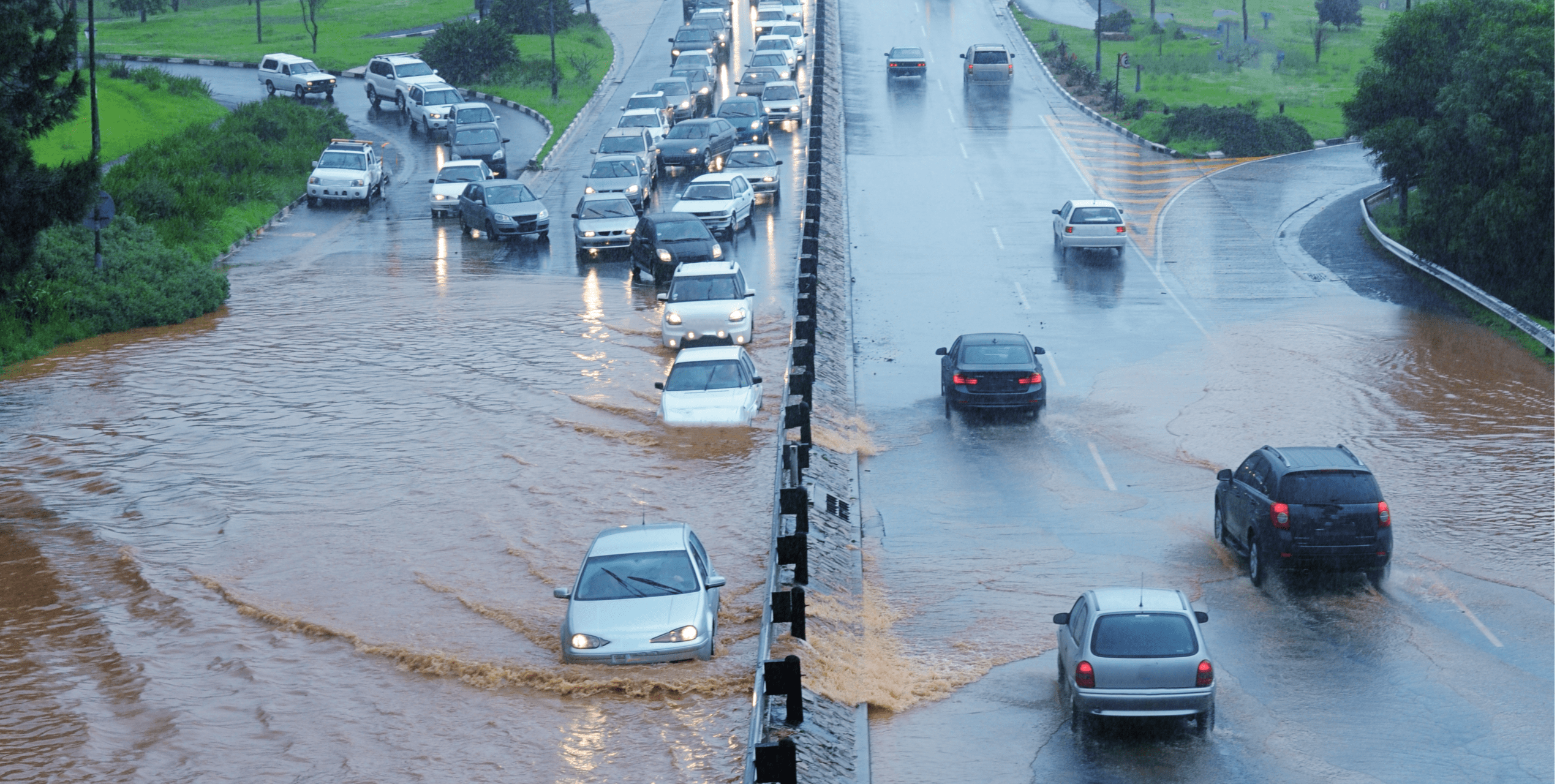Cars driving on a flooded road.